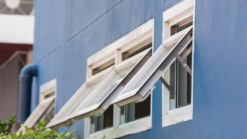 A well-maintained awning window adorned with two white bars, highlighting the effectiveness of the cleaning service provided.