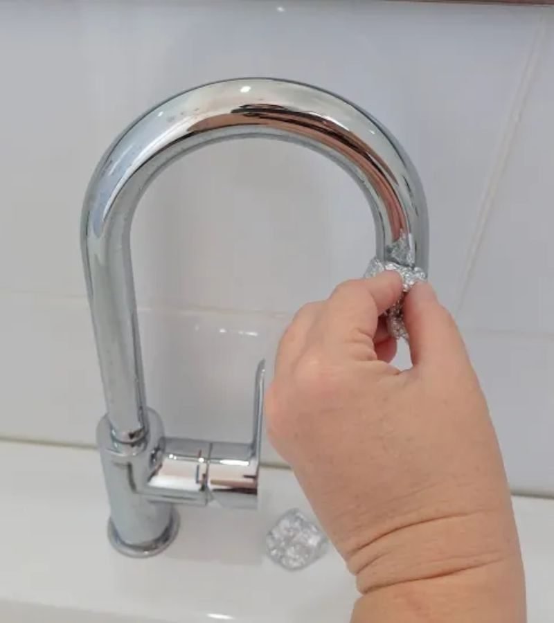 A stained bathroom faucet, showcasing the impact of hard water, emphasizing the importance of a stain removal service.